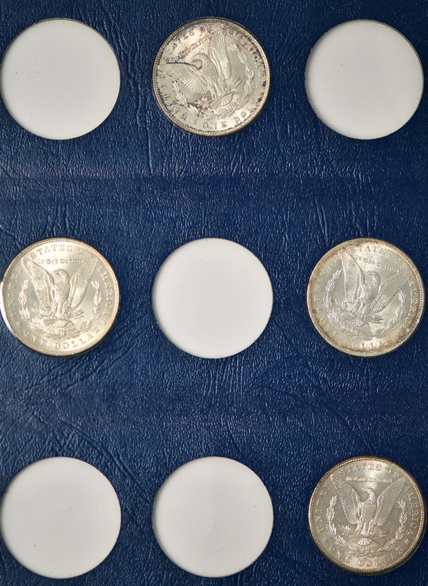 Collection of 26 different Morgan silver dollars in three Whitman albums