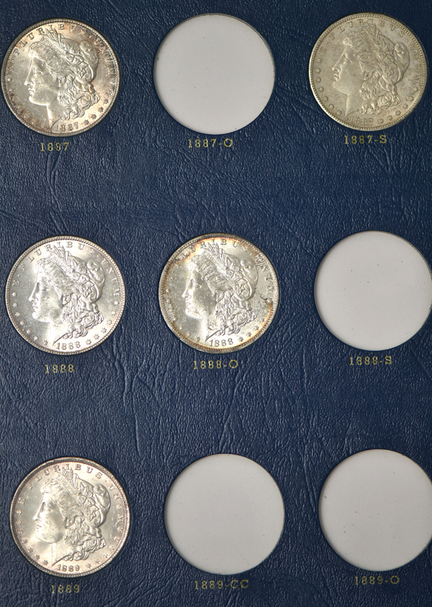 Collection of 26 different Morgan silver dollars in three Whitman albums