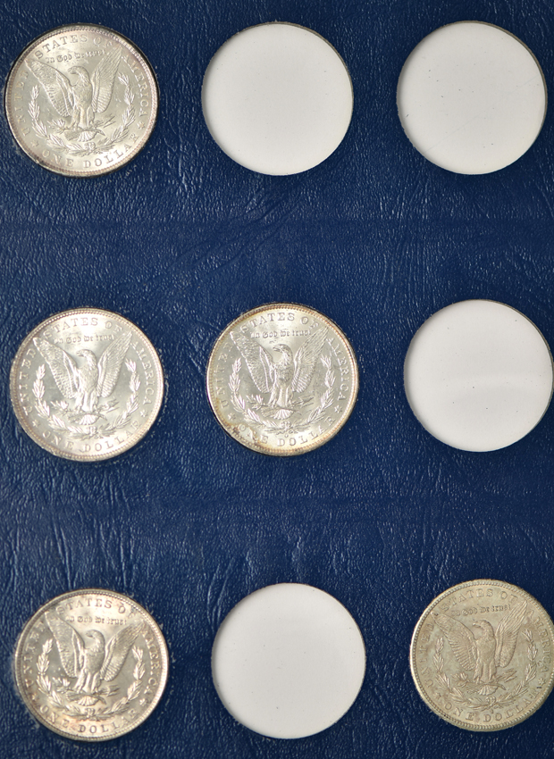 Collection of 26 different Morgan silver dollars in three Whitman albums