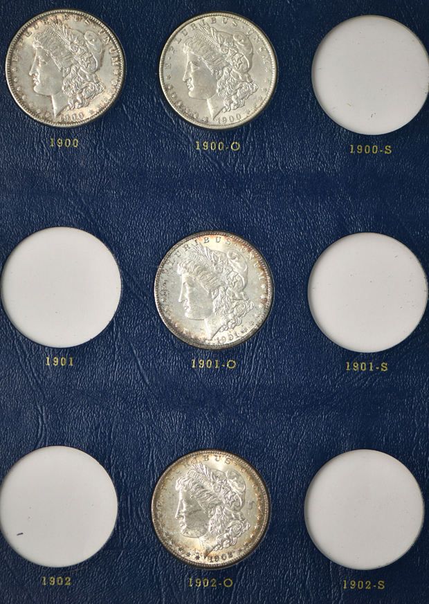 Collection of 26 different Morgan silver dollars in three Whitman albums
