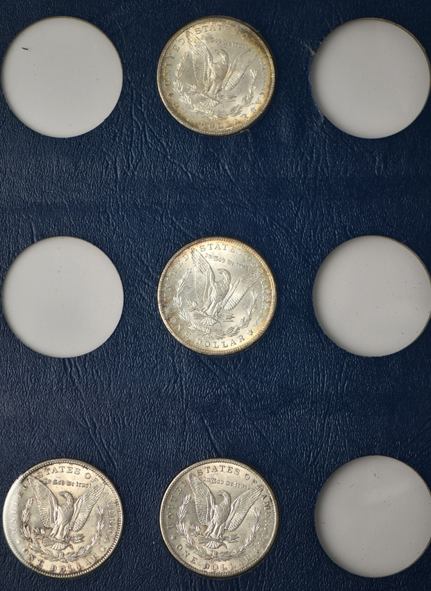 Collection of 26 different Morgan silver dollars in three Whitman albums