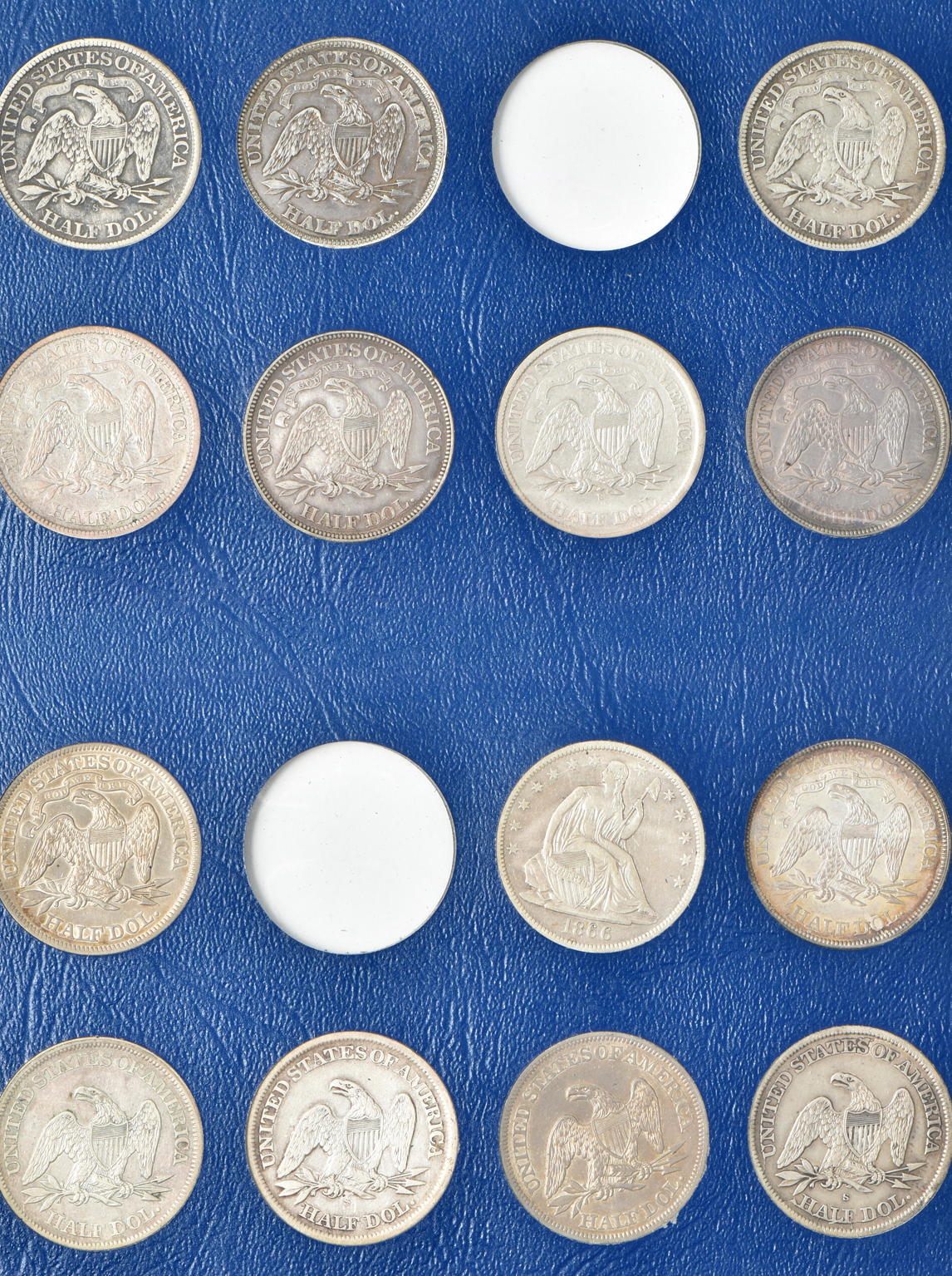 Collection of 33 different Liberty Seated half-dollars in a Whitman 9448 album