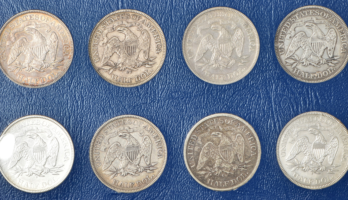 Collection of 33 different Liberty Seated half-dollars in a Whitman 9448 album