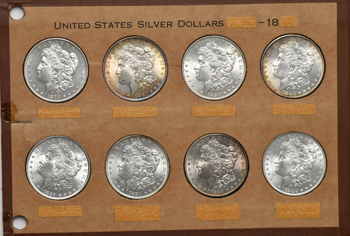 Collection of 32 different Morgan silver dollars in a Wayte Raymond album