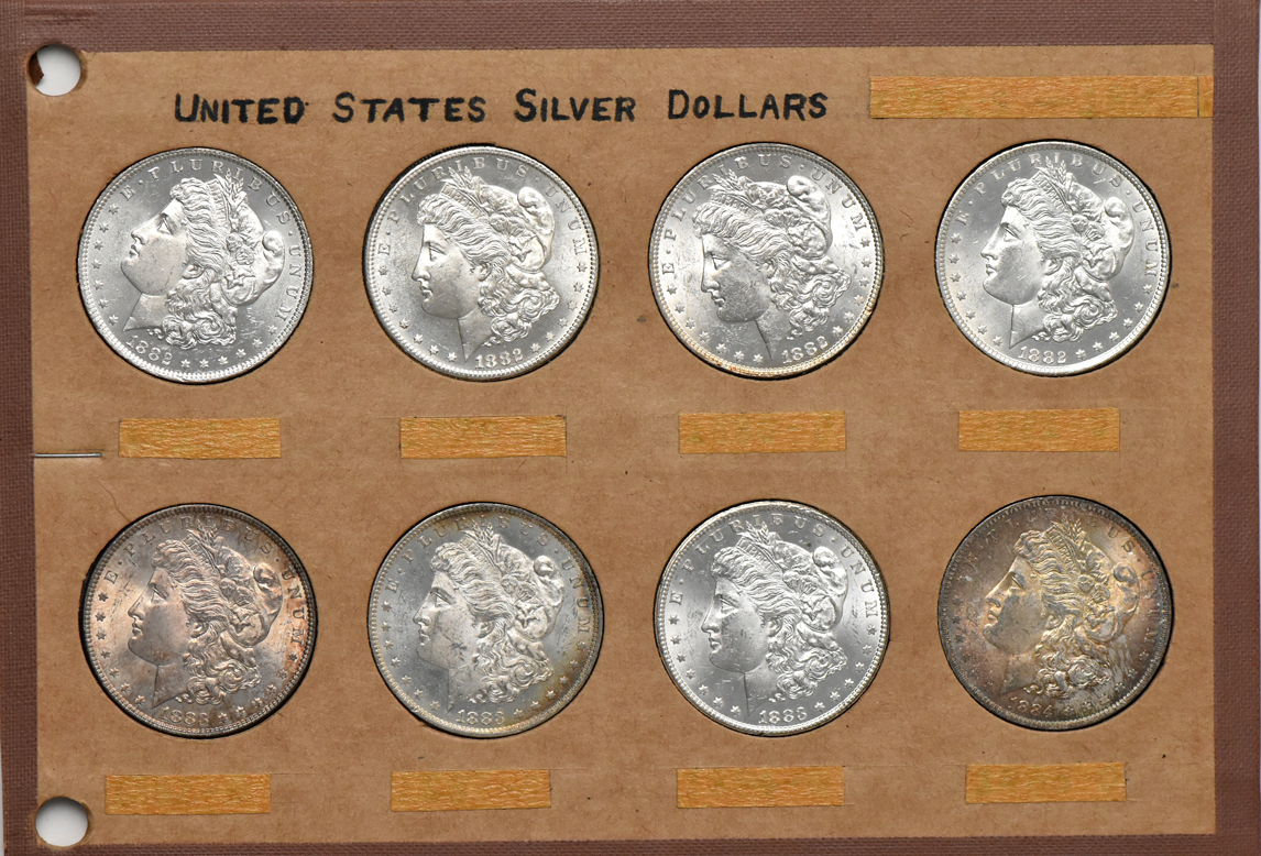 Collection of 32 different Morgan silver dollars in a Wayte Raymond album