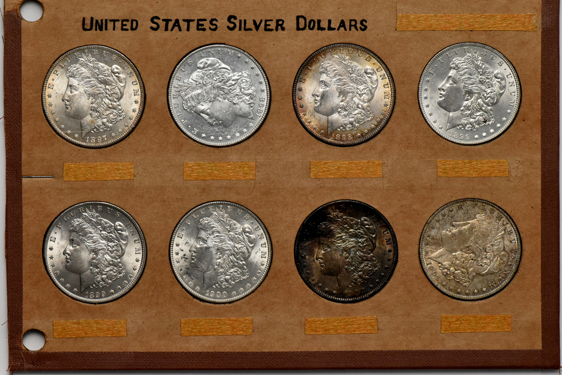 Collection of 32 different Morgan silver dollars in a Wayte Raymond album
