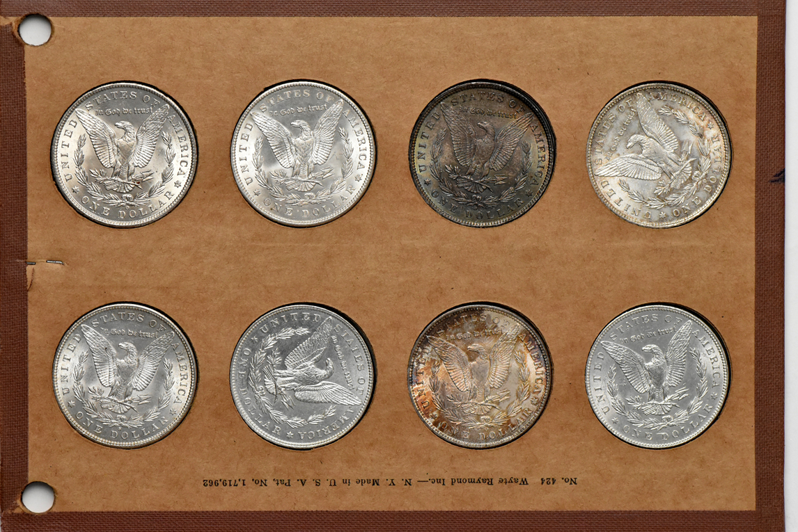 Collection of 32 different Morgan silver dollars in a Wayte Raymond album
