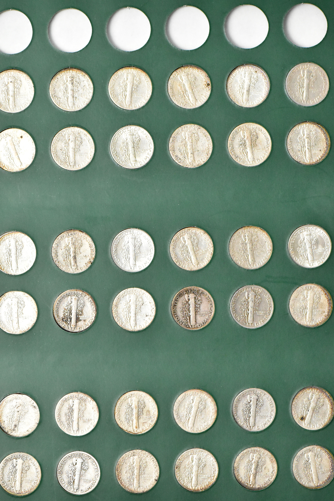Complete collection of Mercury dimes in an album