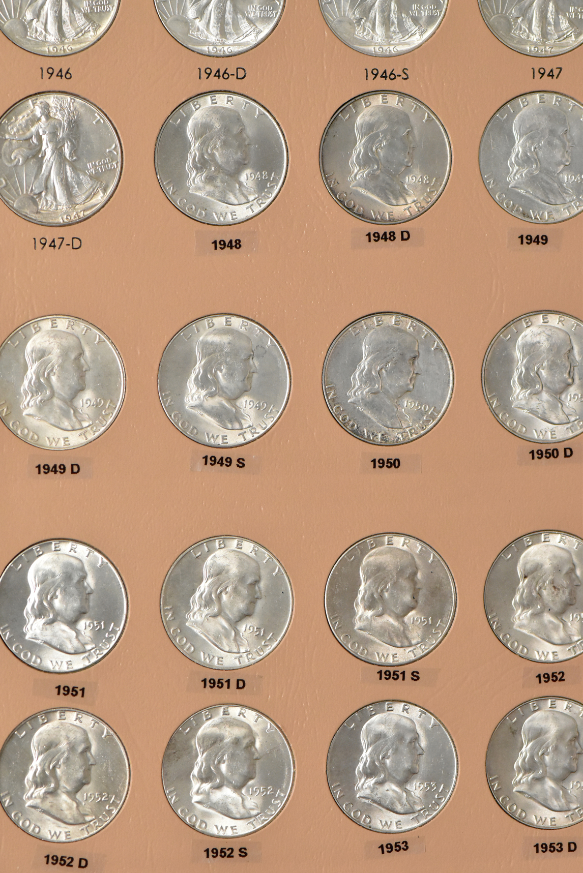 Collections of Walking Liberty and Franklin half-dollars in a Dansco 7160 album