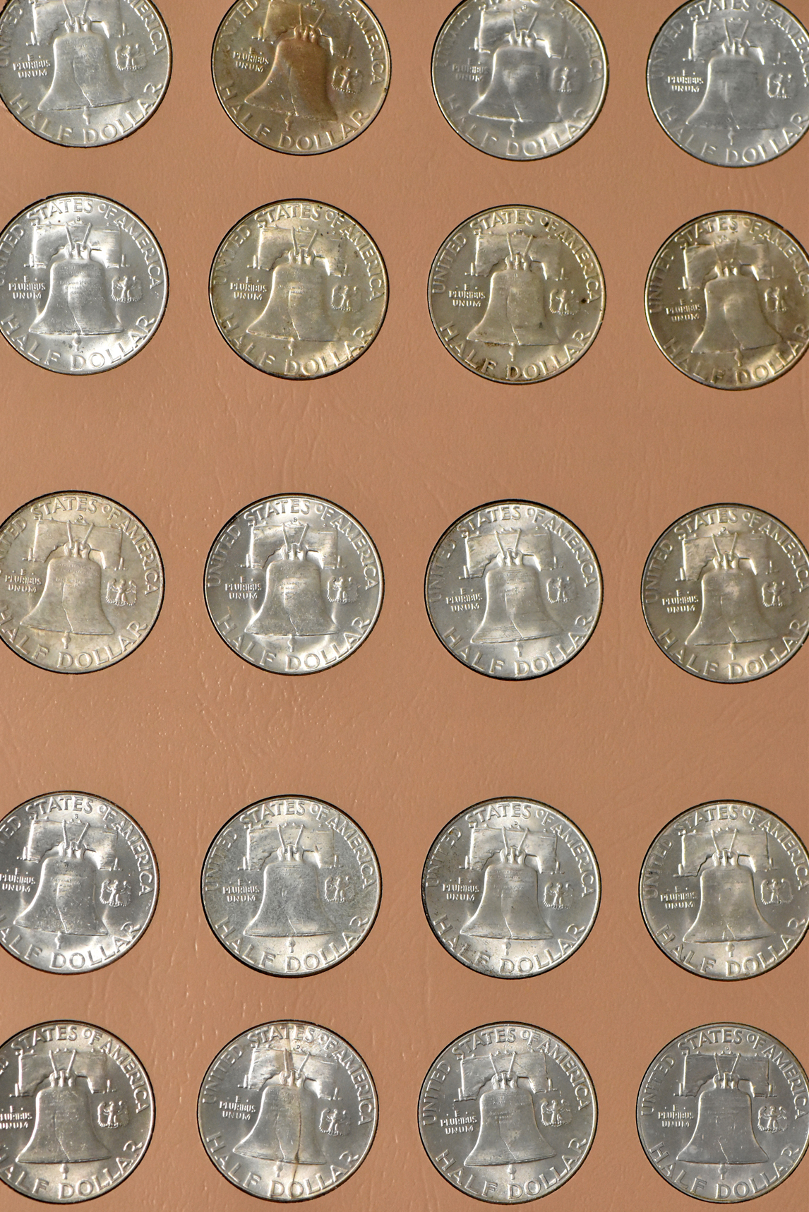 Collections of Franklin half dollars and Jefferson nickels in two Dansco albums