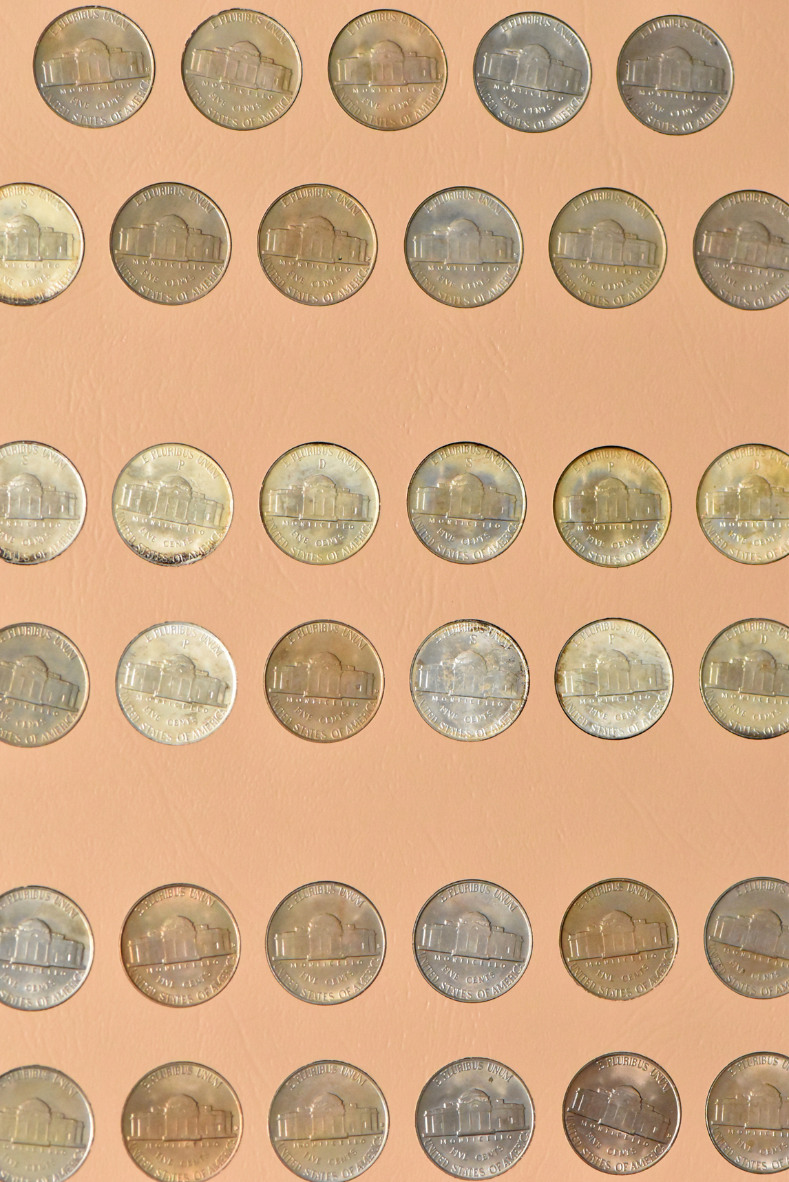 Collections of Franklin half dollars and Jefferson nickels in two Dansco albums