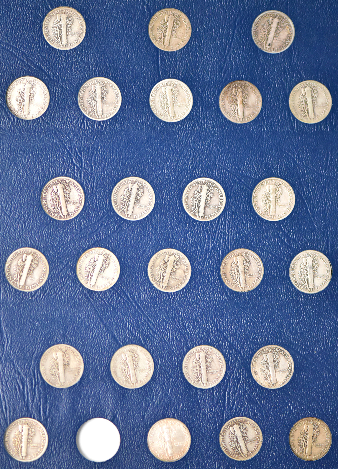Collections of Mercury dimes, Roosevelt dimes, Washington quarters, and Franklin half dollars in four Whitman albums