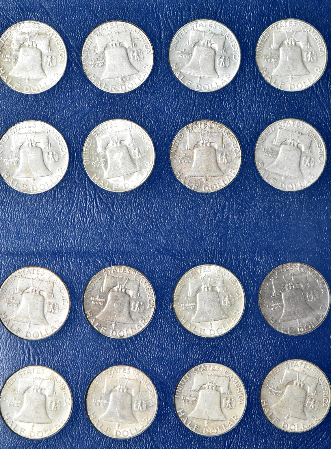 Collections of Mercury dimes, Roosevelt dimes, Washington quarters, and Franklin half dollars in four Whitman albums