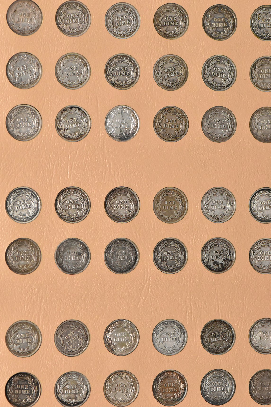 Collection of Barber and Mercury dimes in a Dansco album