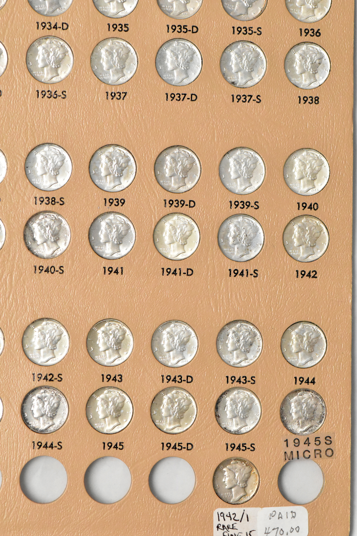 Collection of Barber and Mercury dimes in a Dansco album