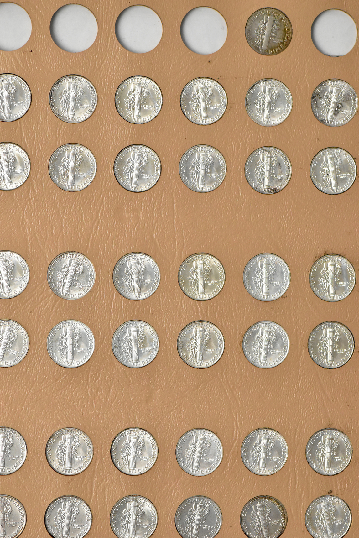 Collection of Barber and Mercury dimes in a Dansco album