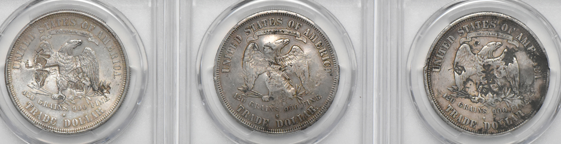 Six chopmarked Trade dollars, plus an 1884-CC Morgan dollar MS-65 (green label), all PCGS