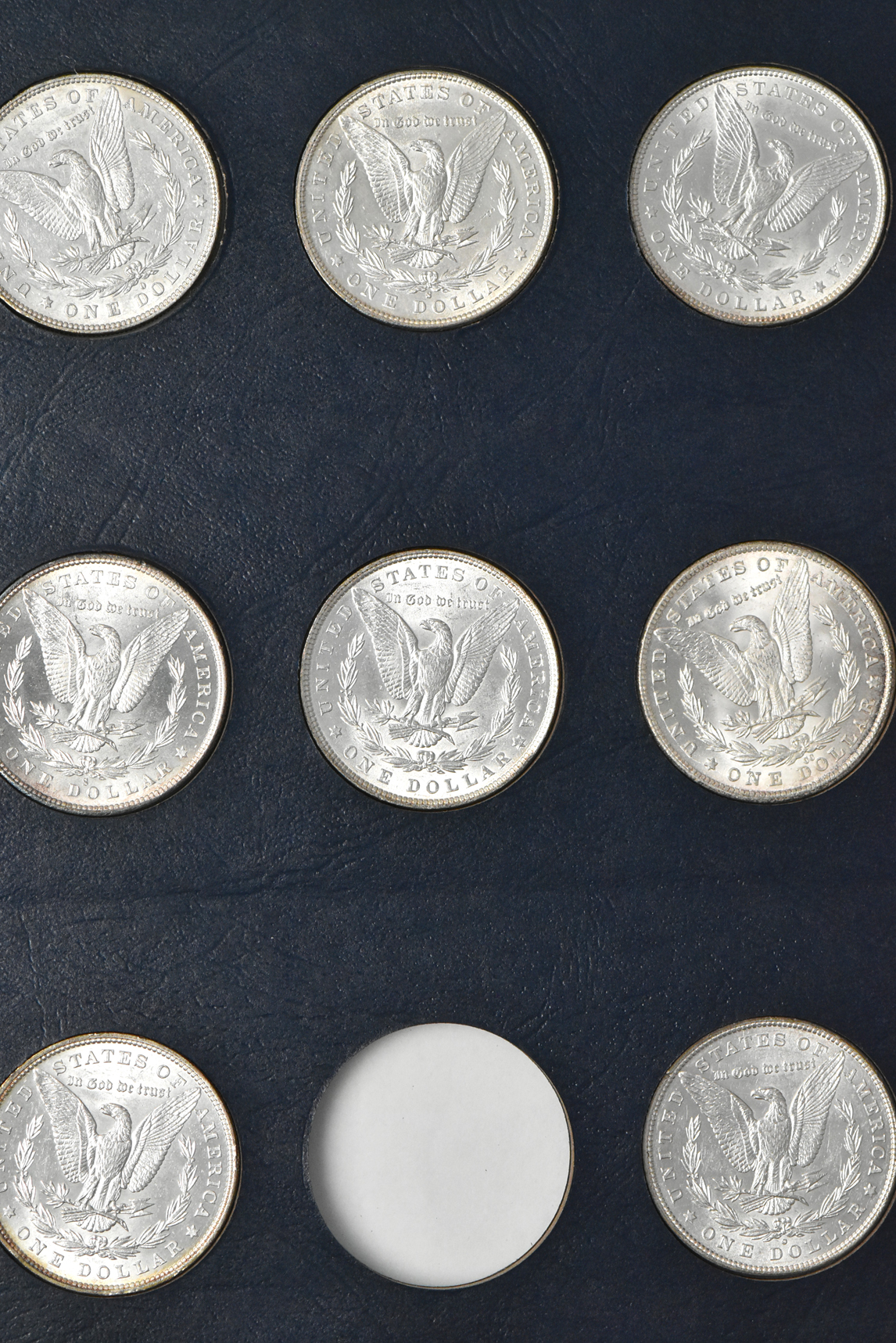 Collection of 44 different Morgan dollars in a Whitman 9128 album