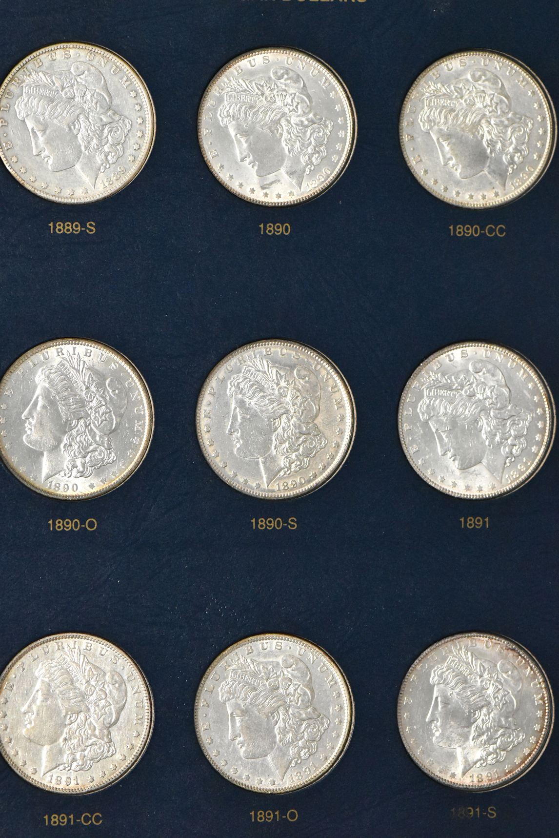 Collection of 44 different Morgan dollars in a Whitman 9128 album