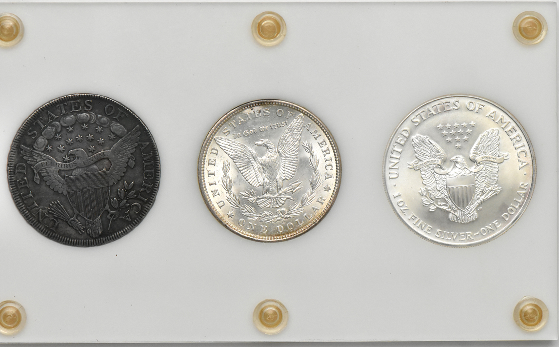1800 Draped Bust silver dollar, 1900-O Morgan silver dollar, and a 2000 American Silver Eagle housed in a Capital Plastics holder