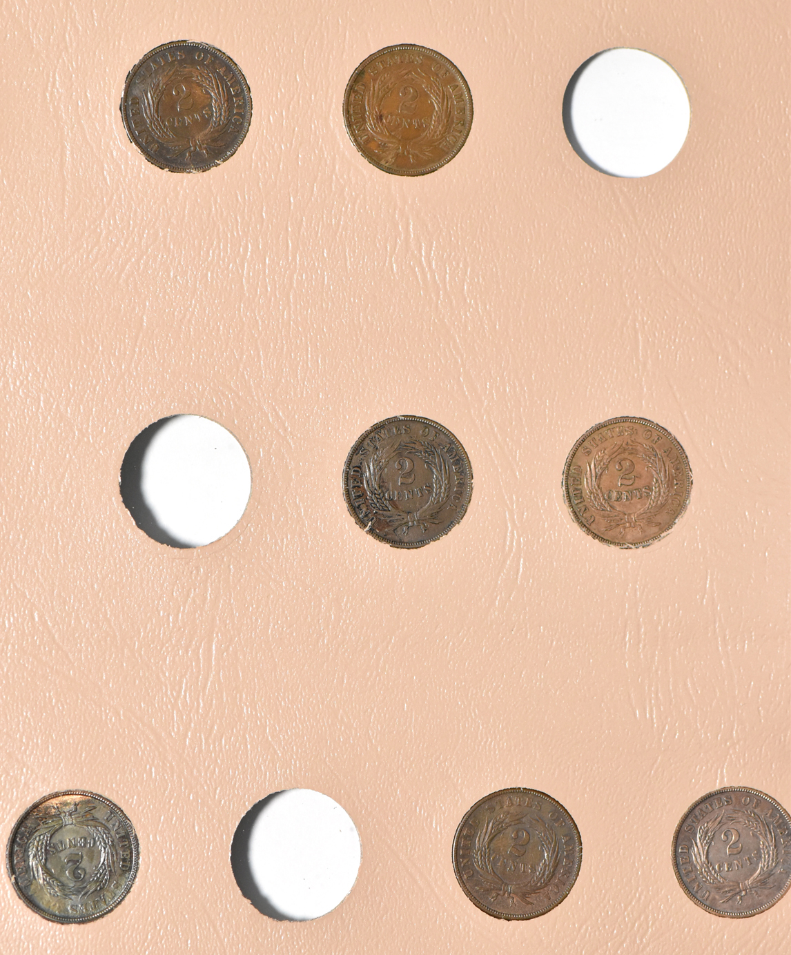 Collection of two-cent pieces and nickel three-cent pieces in a Dansco album