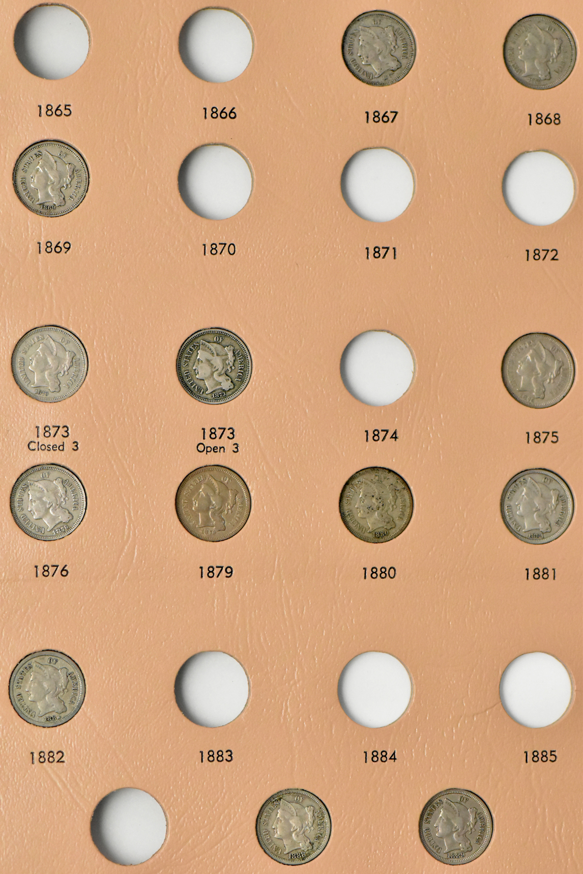 Collection of two-cent pieces and nickel three-cent pieces in a Dansco album