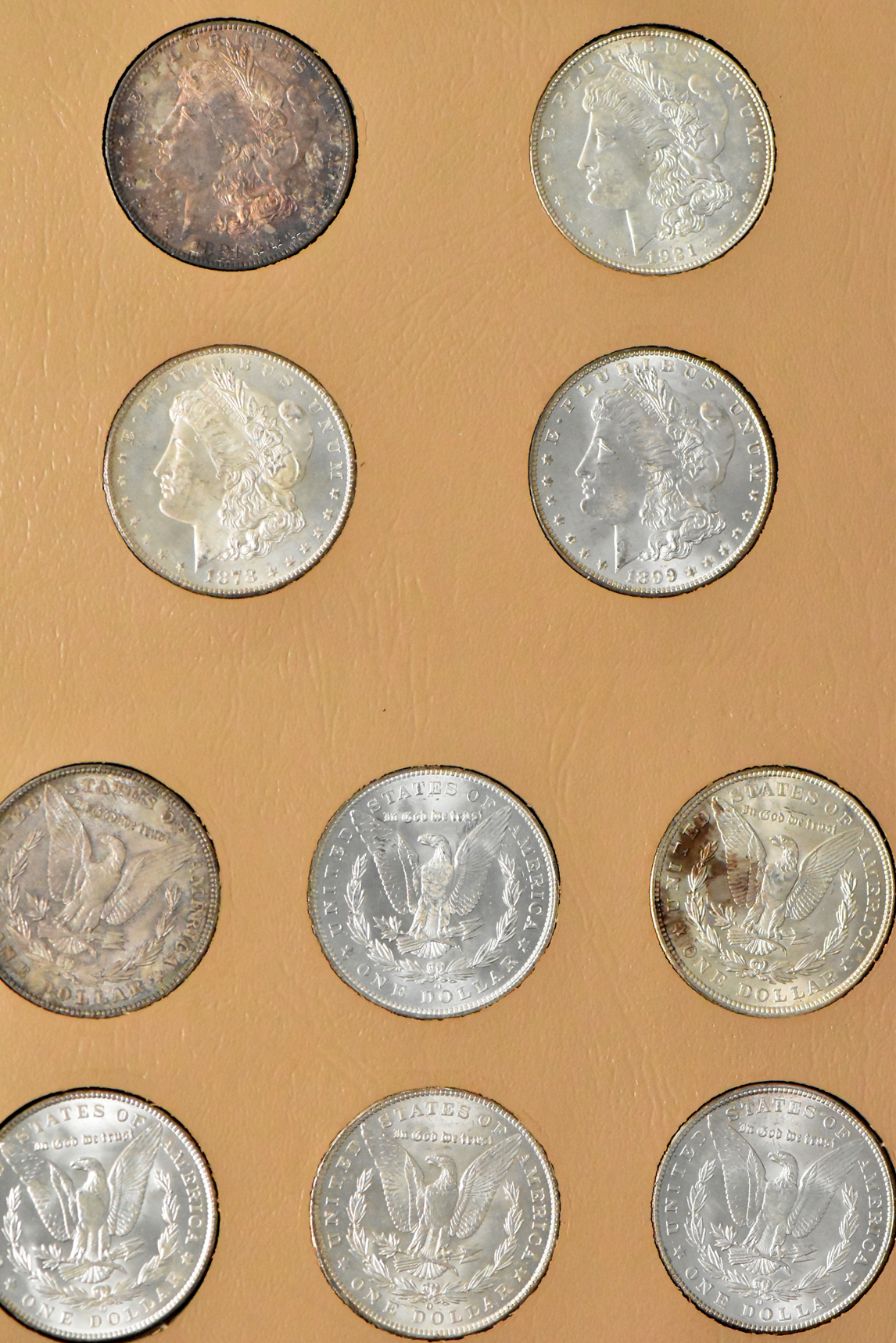 Collection of 23 Morgan dollars in a Whitman 7171 album