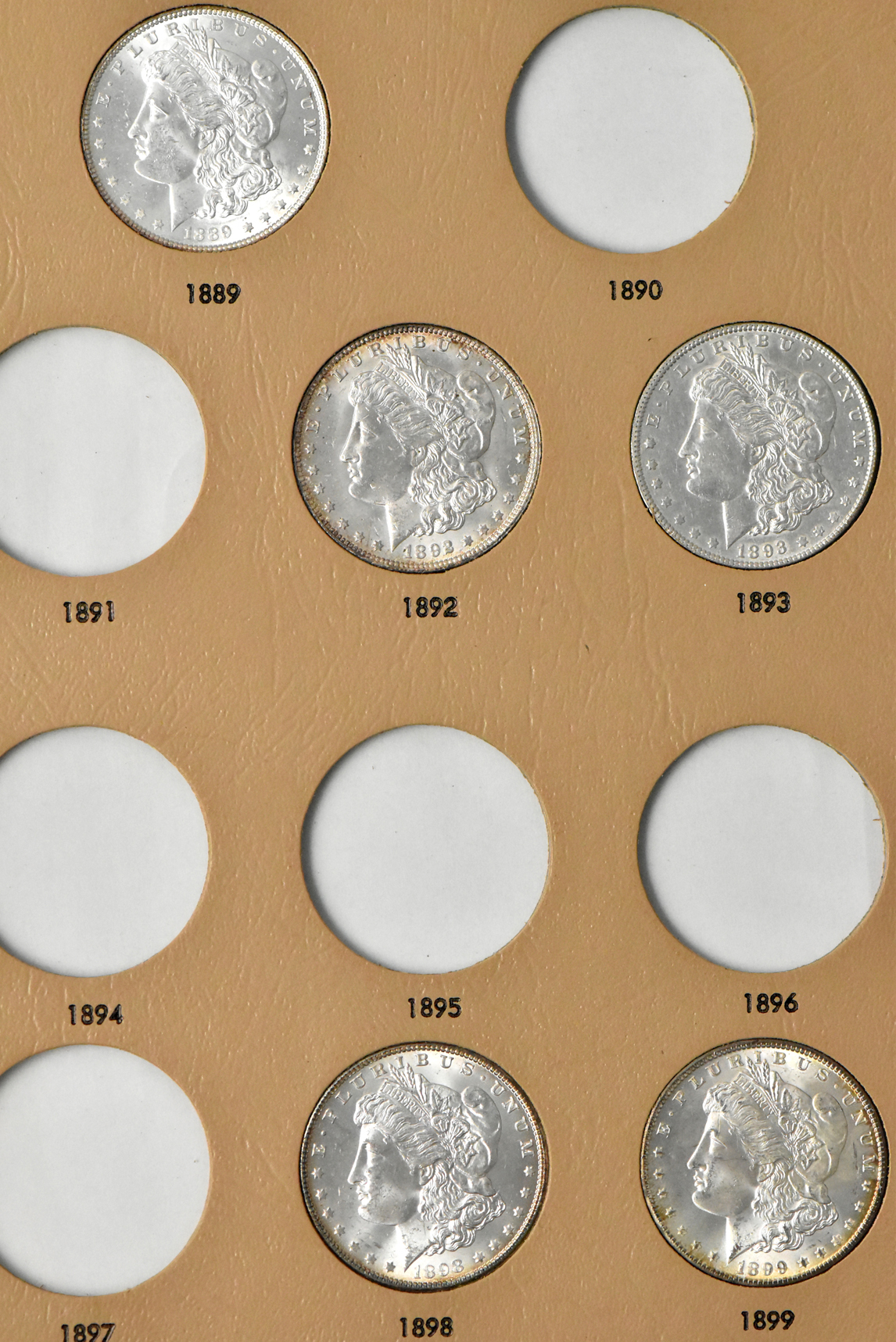 Collection of 23 Morgan dollars in a Whitman 7171 album