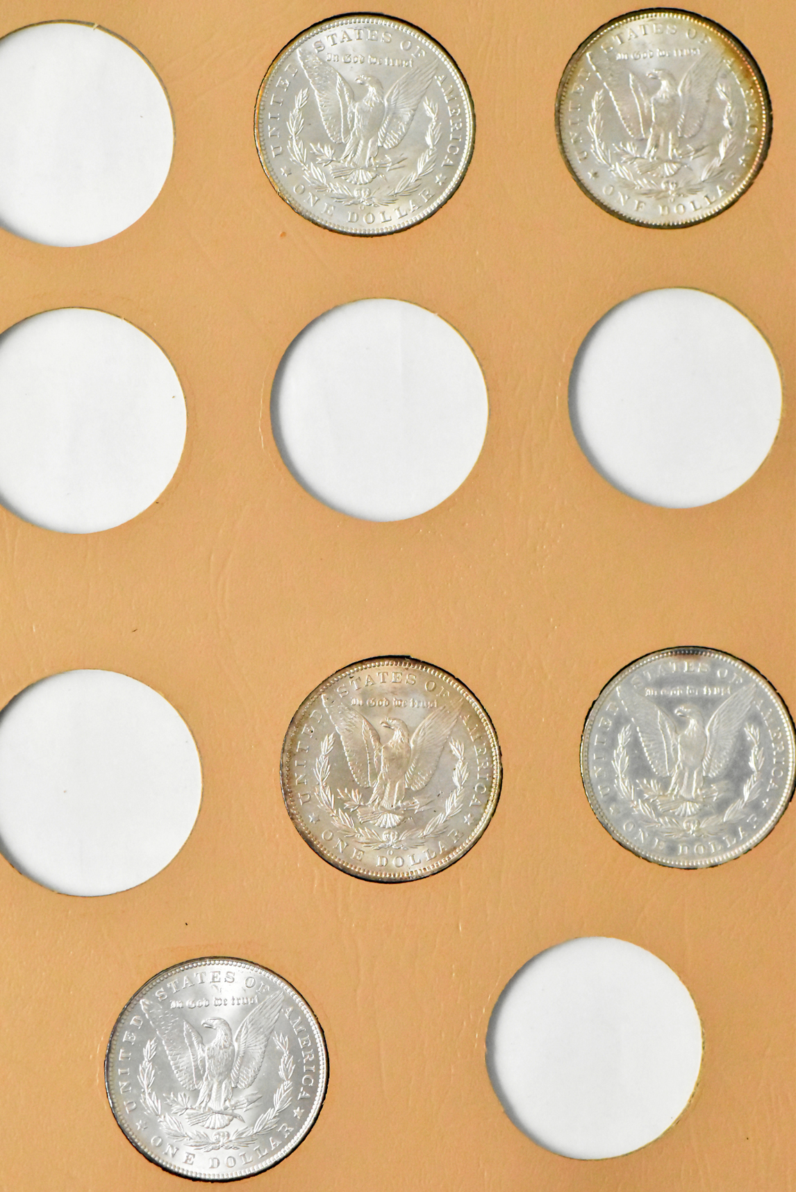 Collection of 23 Morgan dollars in a Whitman 7171 album