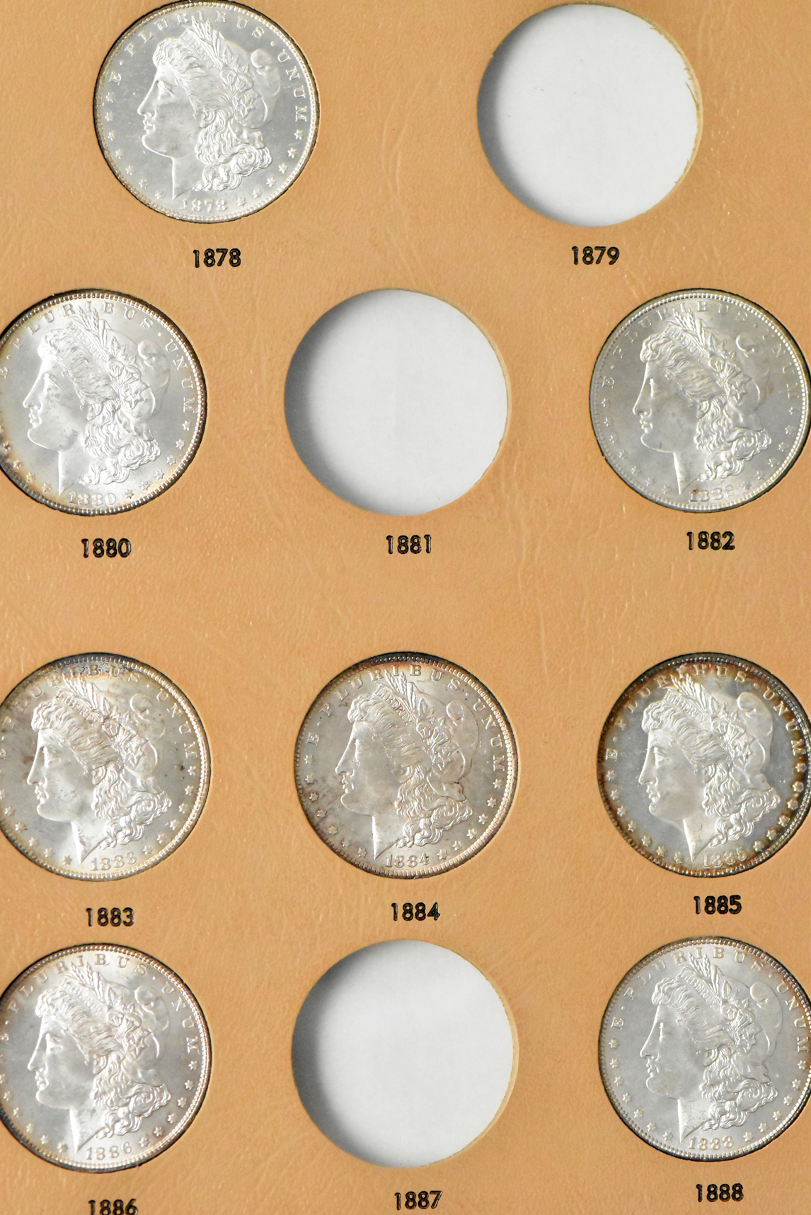 Collection of 23 Morgan dollars in a Whitman 7171 album