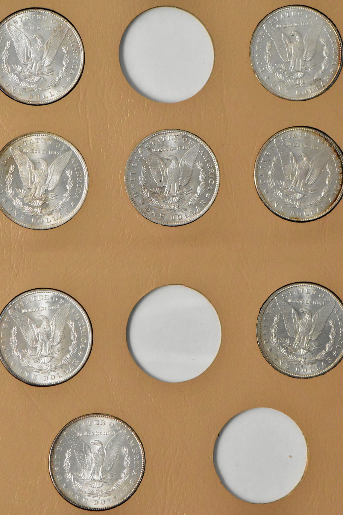Collection of 23 Morgan dollars in a Whitman 7171 album