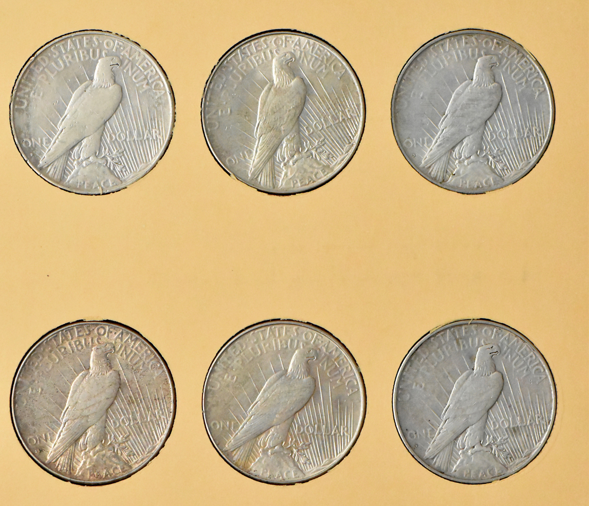 Collection of 24 Peace dollars in a complete Library of Coins Vol. 26 album