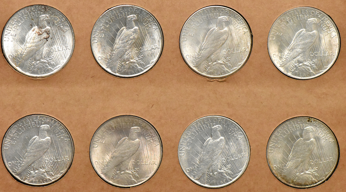 Collection of Peace dollars in a complete Wayte Raymond album