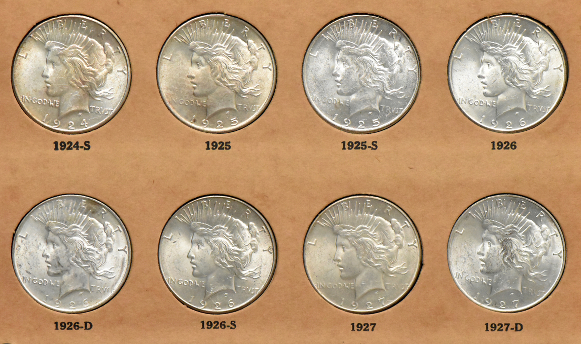 Collection of Peace dollars in a complete Wayte Raymond album