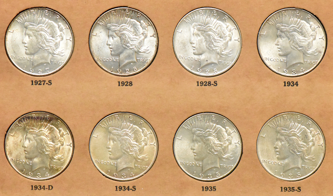 Collection of Peace dollars in a complete Wayte Raymond album