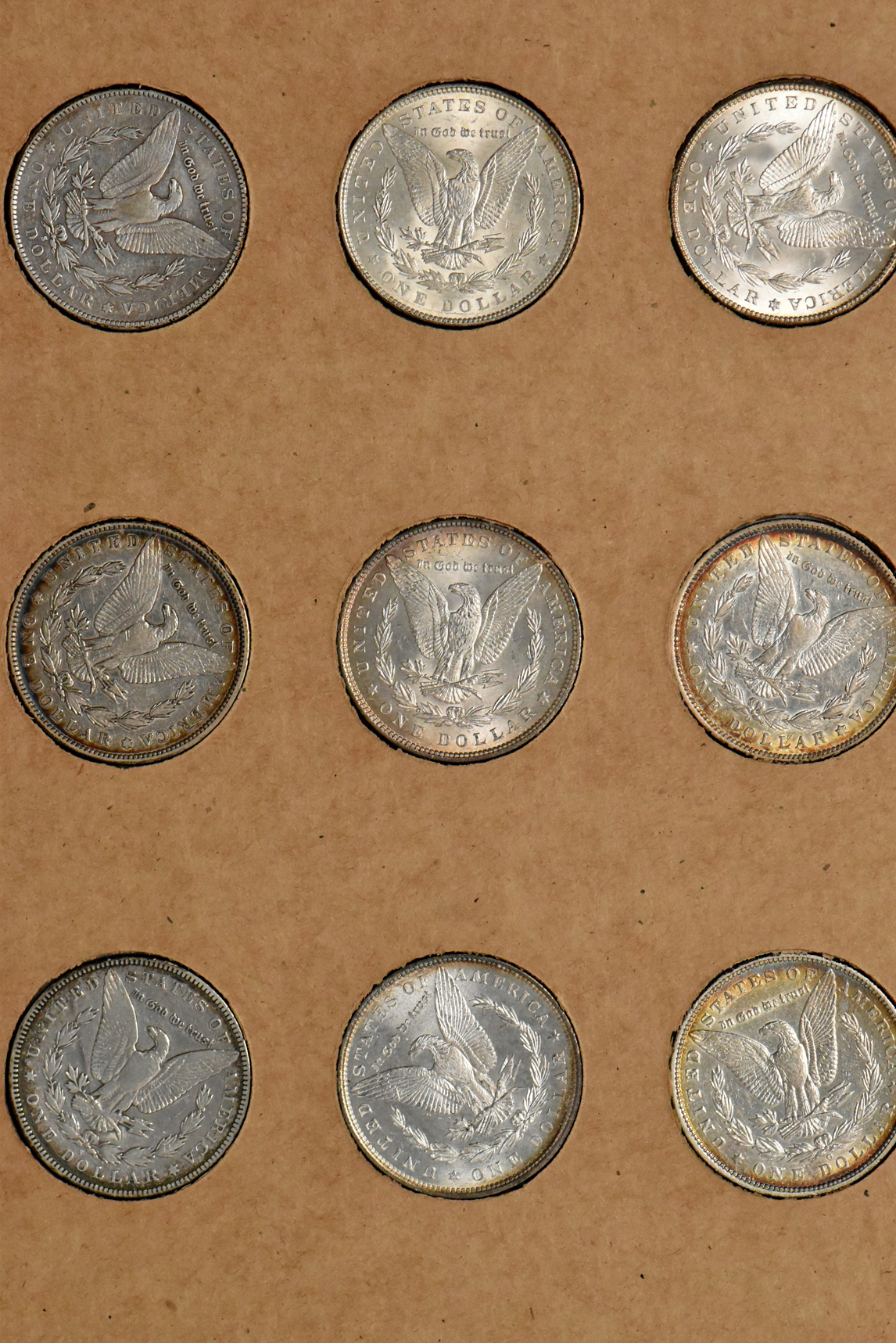 Collection of 34 different Morgan silver dollars in a The National Coin Album