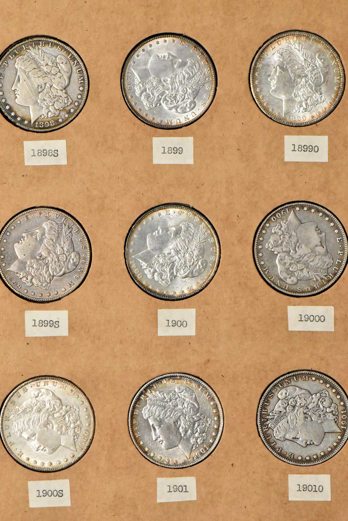 Collection of 34 different Morgan silver dollars in a The National Coin Album