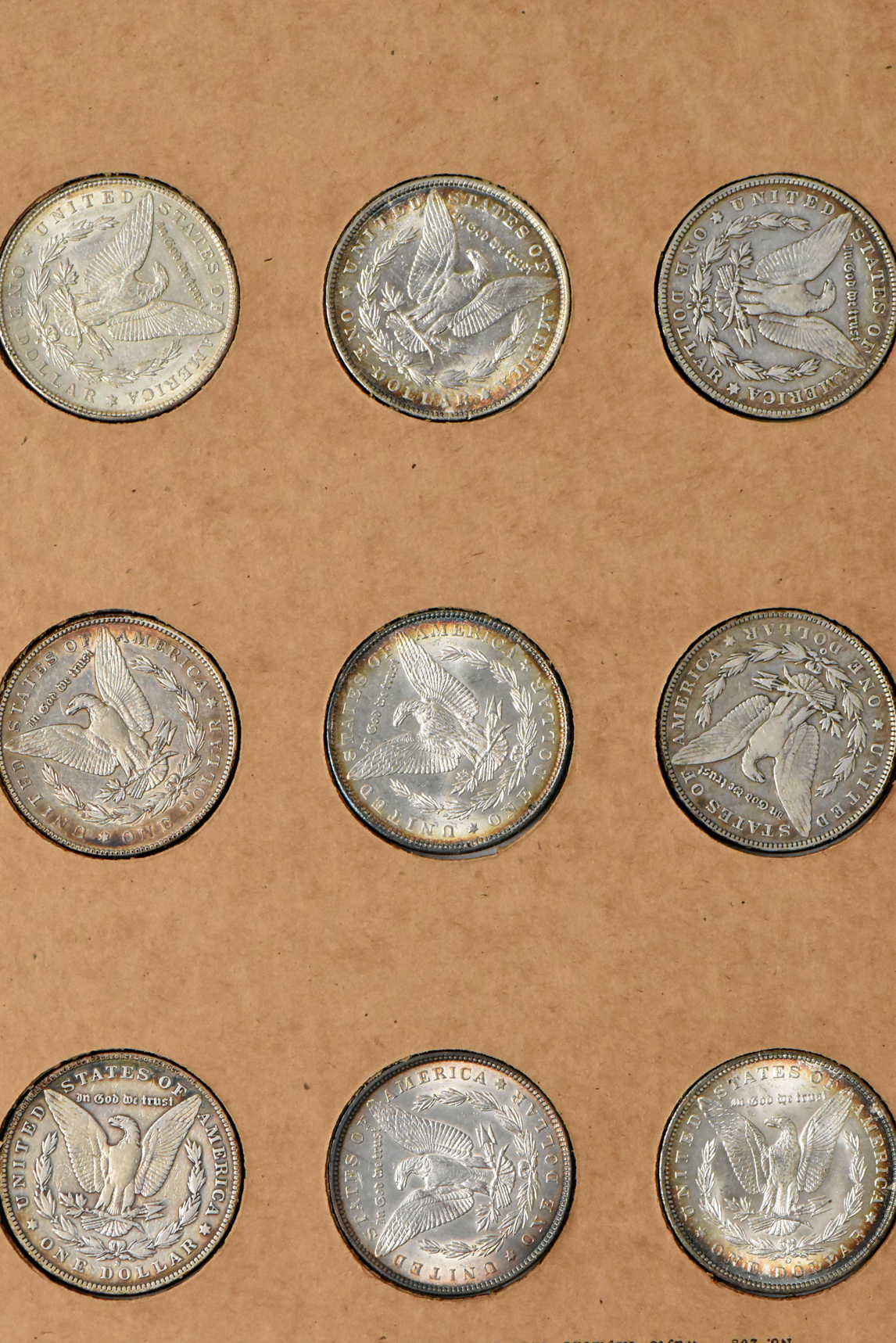 Collection of 34 different Morgan silver dollars in a The National Coin Album
