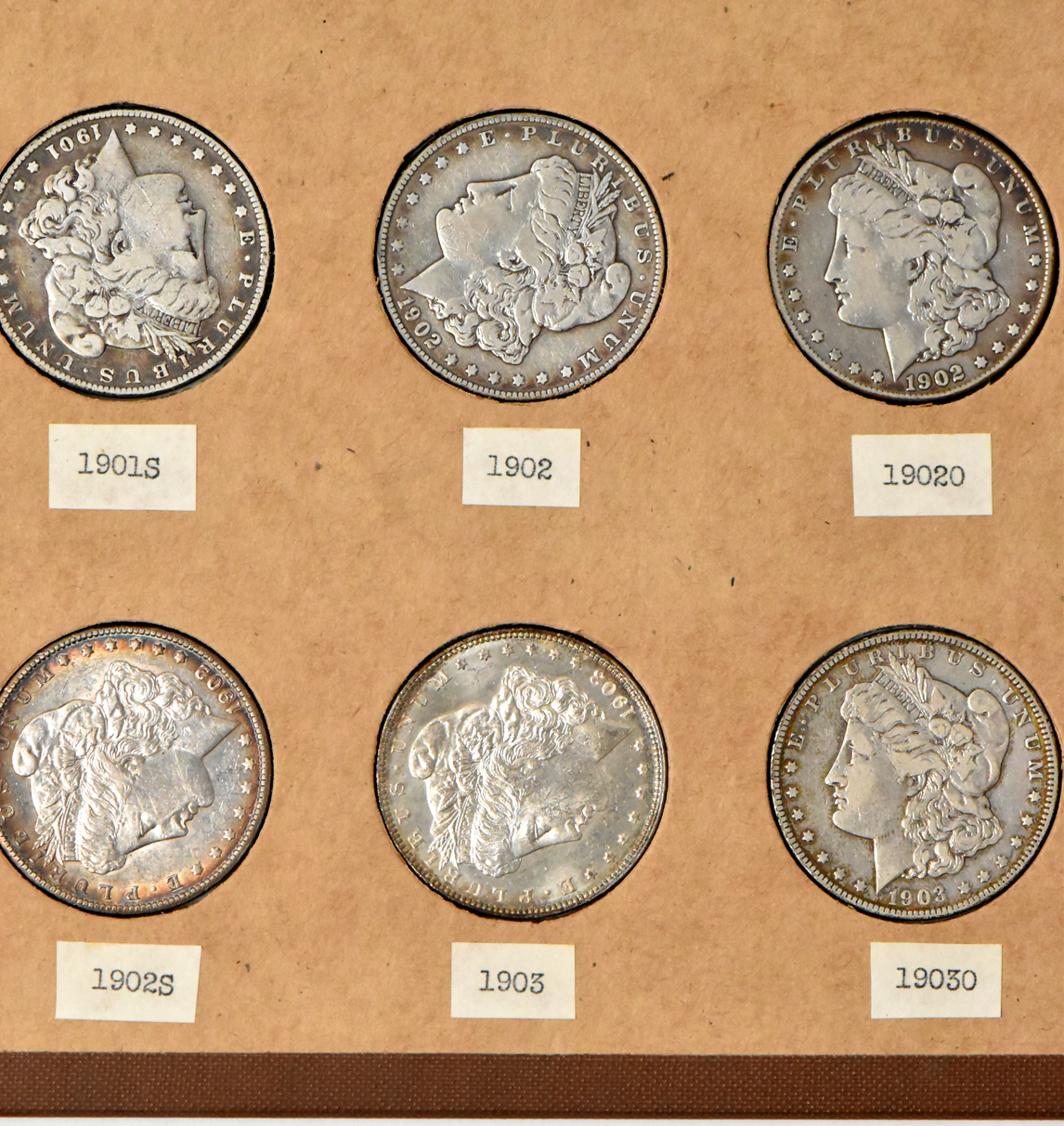 Collection of 34 different Morgan silver dollars in a The National Coin Album