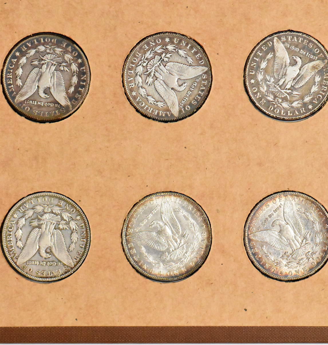 Collection of 34 different Morgan silver dollars in a The National Coin Album