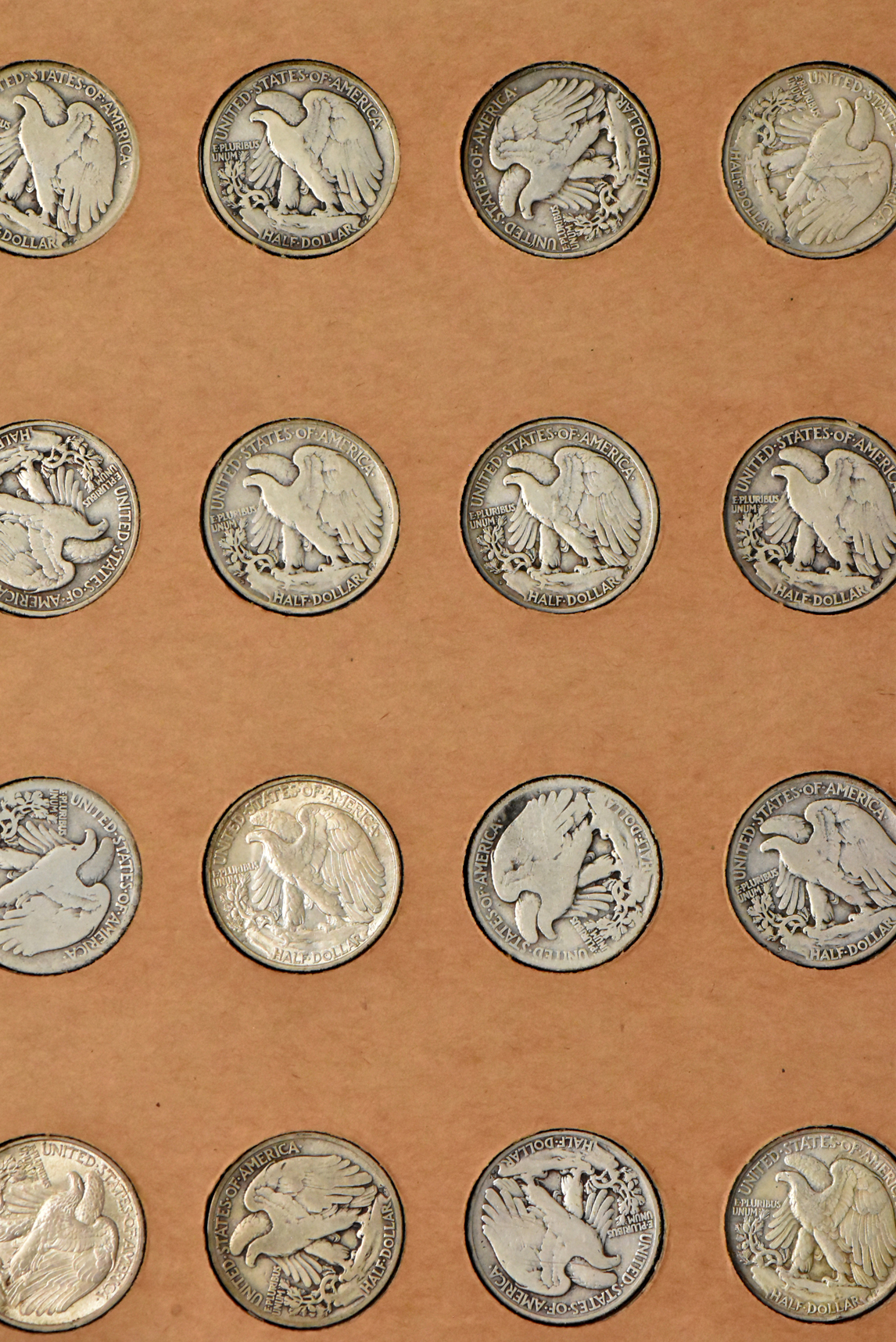 Collection of 58 different Walking Liberty half dollars and 27 Franklin half dollars in a The National Coin Album
