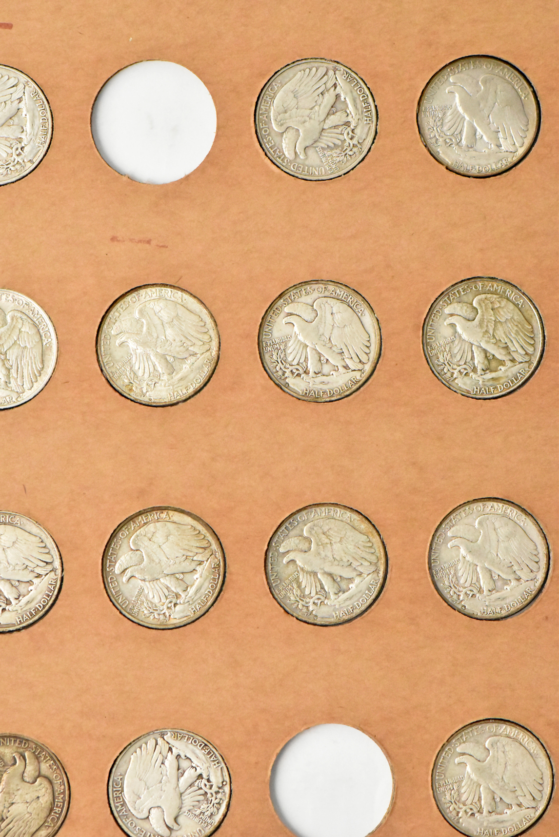 Collection of 58 different Walking Liberty half dollars and 27 Franklin half dollars in a The National Coin Album