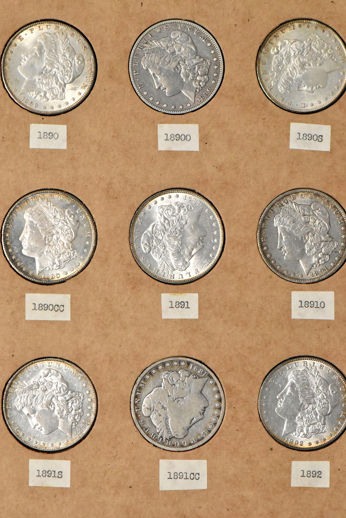 Collection of 50 different Morgan dollars in a The National Coin Album 