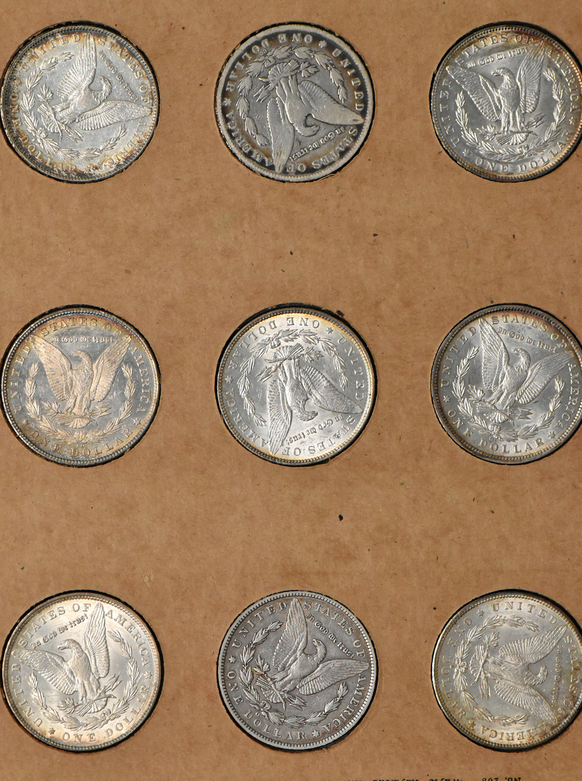 Collection of 50 different Morgan dollars in a The National Coin Album 