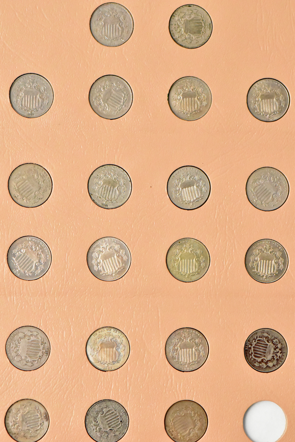 Collections of two-cent pieces, Shield nickels, and Liberty nickels in a Dansco album