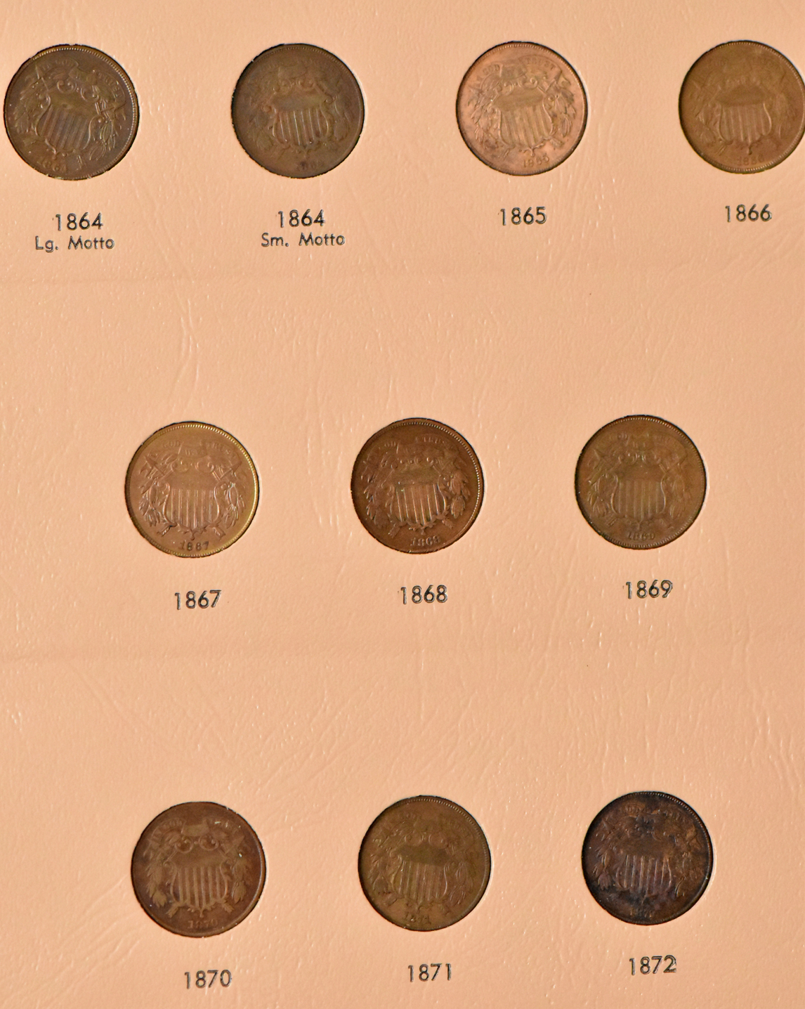 Collections of two-cent pieces, Shield nickels, and Liberty nickels in a Dansco album