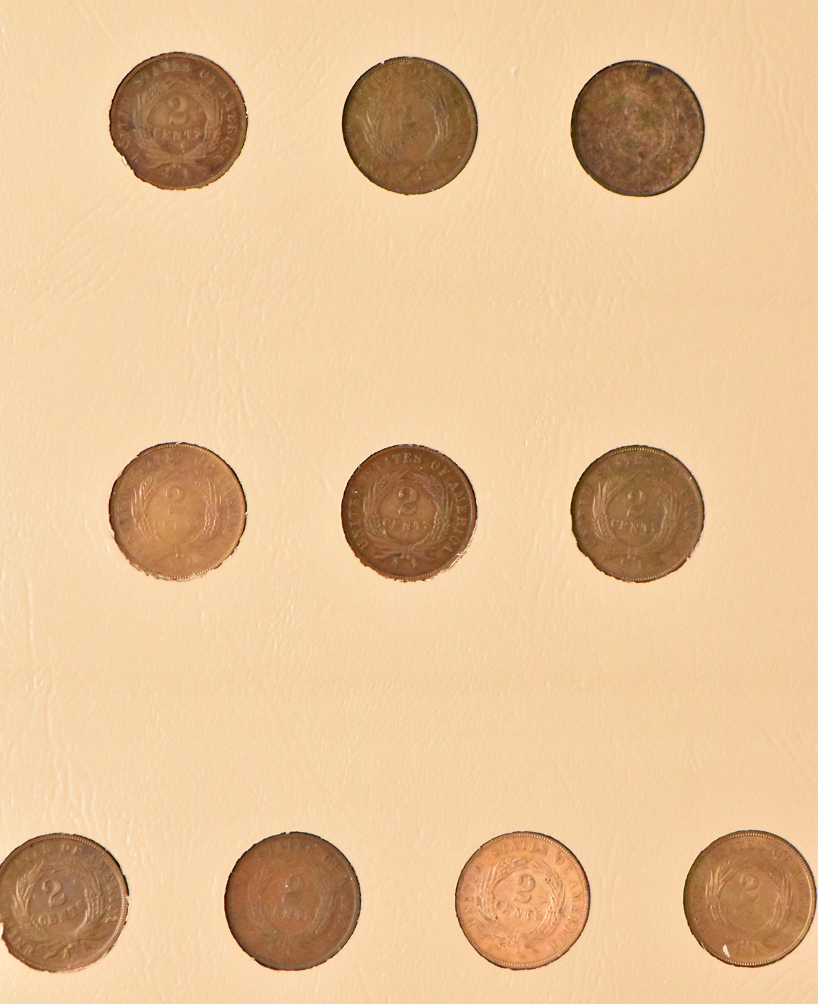 Collections of two-cent pieces, Shield nickels, and Liberty nickels in a Dansco album