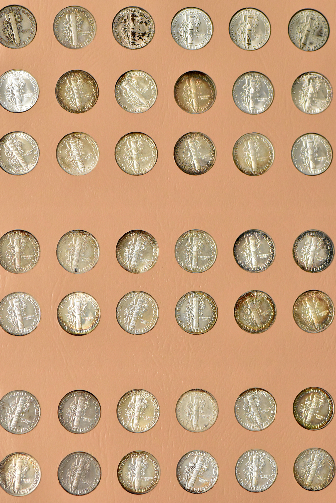 Collection of Mercury dimes, plus extras, in a complete Dansco 7123 album