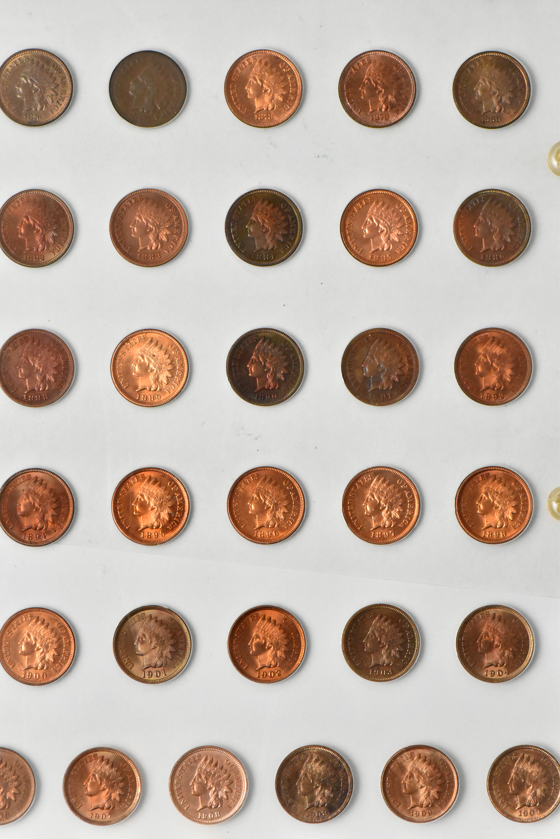 Three Flying Eagle cents and 55 Indian cents in a Capital Plastics like holder