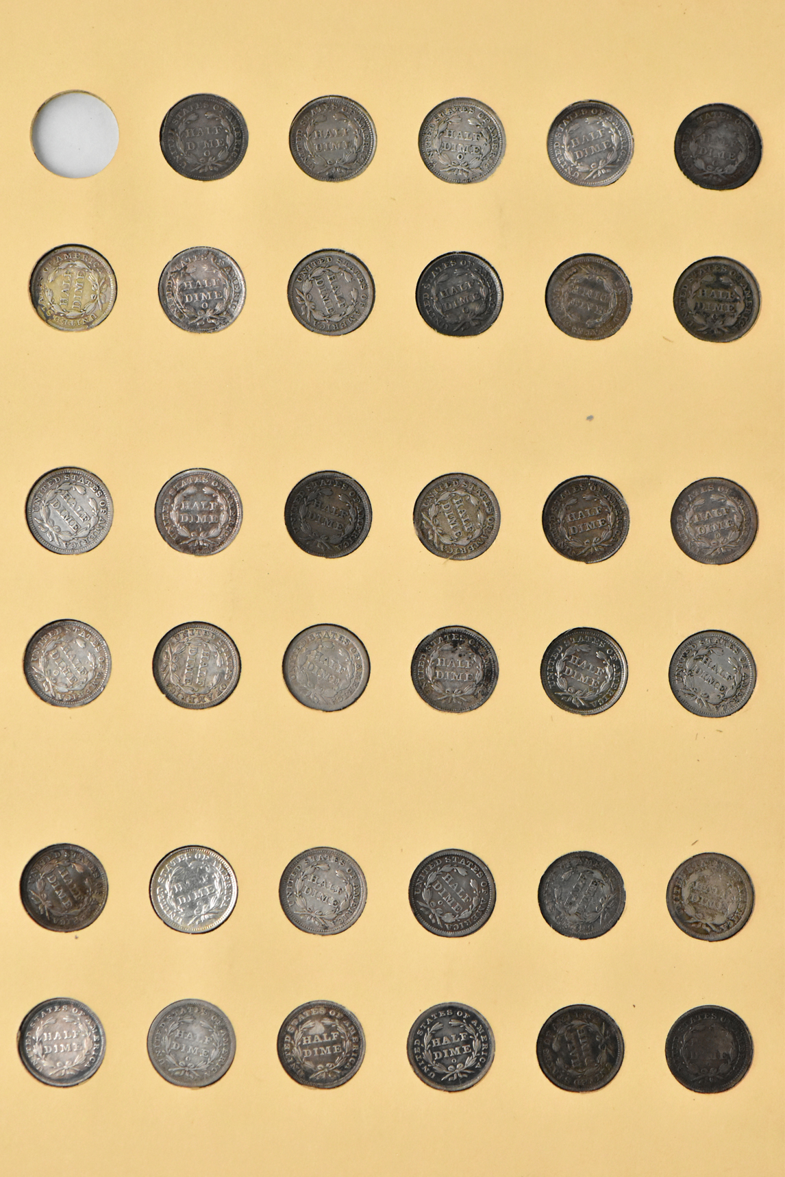 Collection of 86 different half dimes in a Library of Coins Vol. 40 album